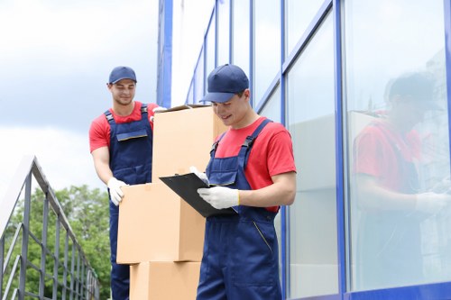 Loading boxes and household items into a moving van in Wembley