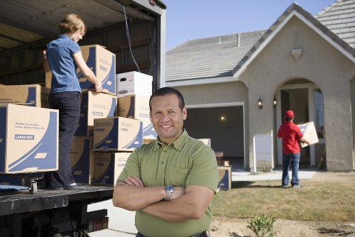 Local moving team organising boxes inside a Wembley apartment